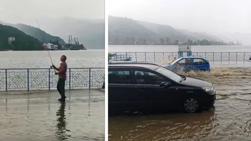 VIDEO incredibil! Un bărbat pescuiește pe faleza din Orșova, după ce o ploaie torențială a inundat toată zona