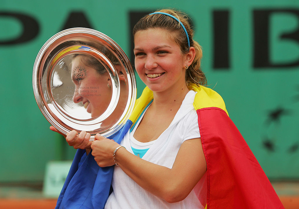 PARIS - JUNE 08:  Simona Halep of Romania celebrates her victory during the Girl's Singles Final match against Elena Bogdan of Romania on day fifteen of the French Open at Roland Garros on June 8, 2008 in Paris, France.  (Photo by Matthew Stockman/Getty Images)