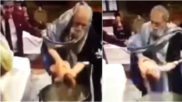 Imagini şocante: un preot bruschează un bebeluş în timpul botezului! Reacţia Patriarhiei 