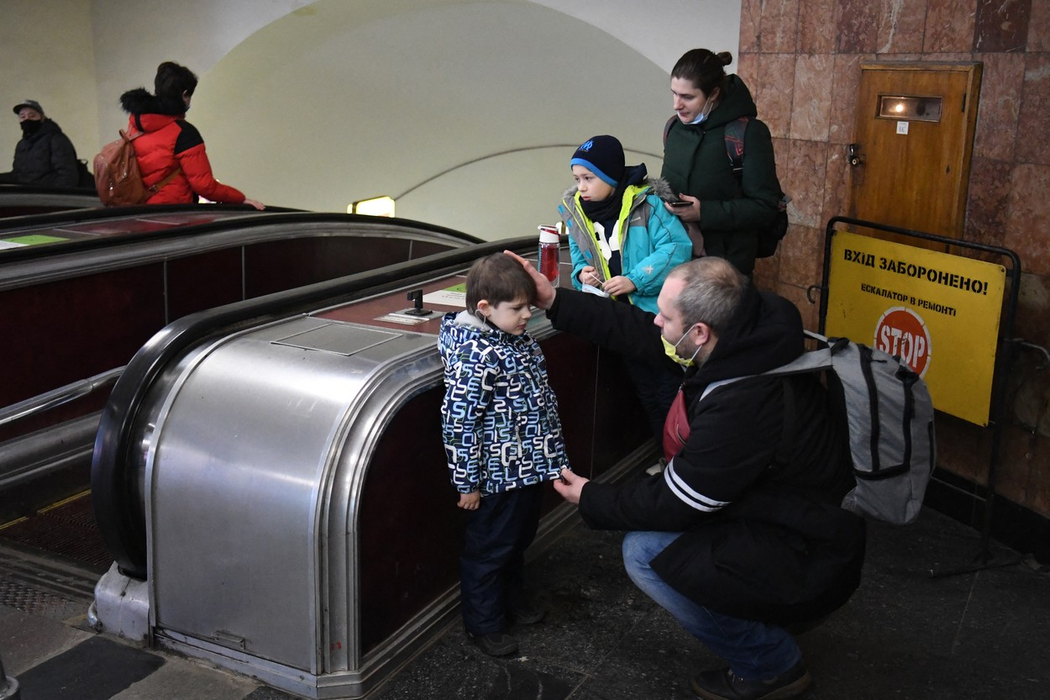 Tatăl își liniștește fiul, în timp ce familia se refugiază într-o stație de metrou din Kiev, în dimineața zilei de 24 februarie 2022. (Sursa foto: profimedia.ro)