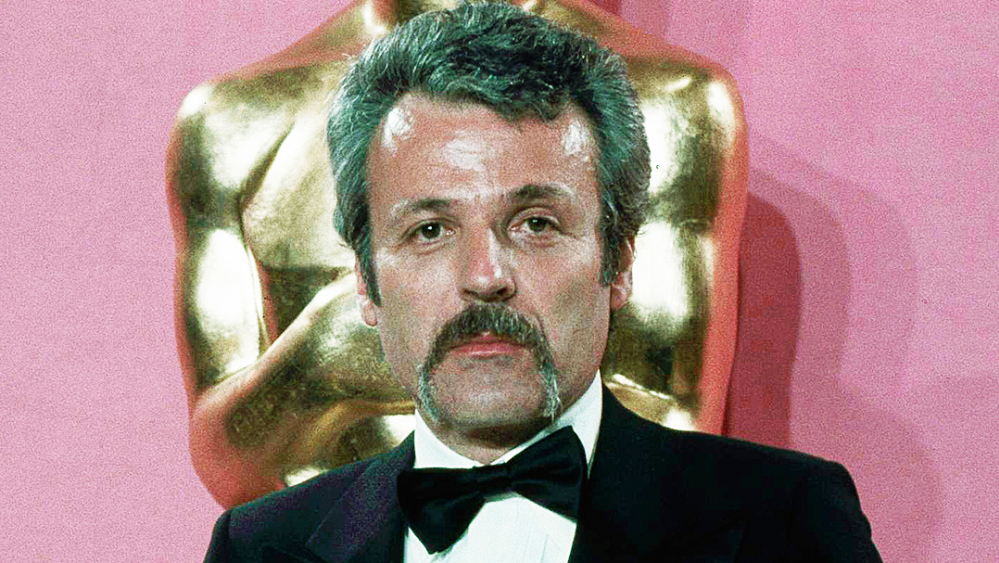Bearded Paddy Chayefsky holding Oscar he won for best original Screenplay for "Network" and William Goldman who won the Oscar for best Screenplay from another medium for "All the President's Men" at the 49th Academy Award presentation at Los Angeles Music Center, March 28, 1977.(AP Photo/Pendergrass)