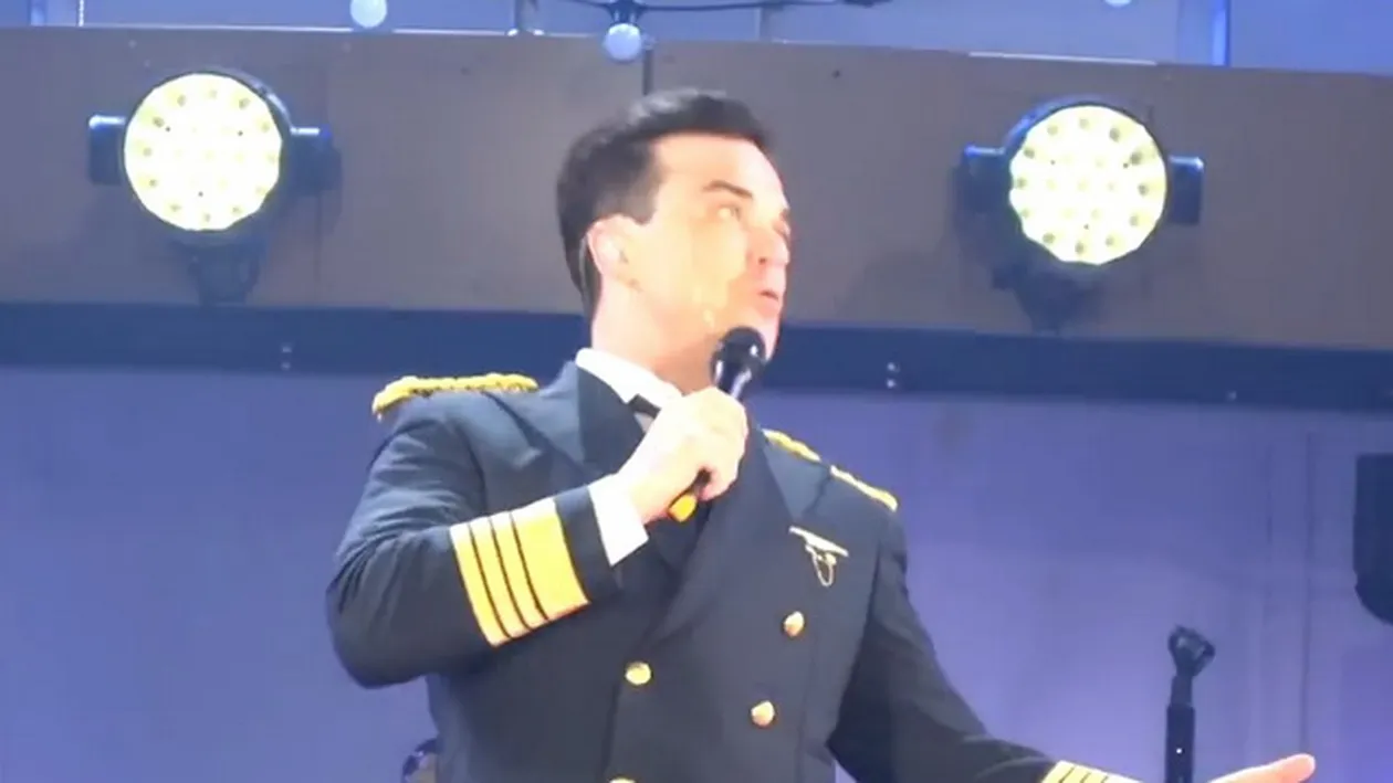Scene de COSMAR la concertul lui Robbie Williams! Cantaretul a cazut de pe scena si a rupt mana unei femei! VIDEO