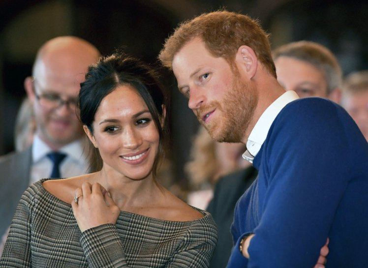 Britain's Prince Harry and Meghan Markle watch a dance performance by Jukebox Collective Cardiff Castle in Cardiff, Wales, Thursday, Jan. 18, 2018. During their tour, Prince Harry and Ms. Markle will hear performances from musicians and poets, meet sportsmen and women, and see how organisations are working to promote Welsh language and cultural identity. (Ben Birchall/Pool Photo via AP)