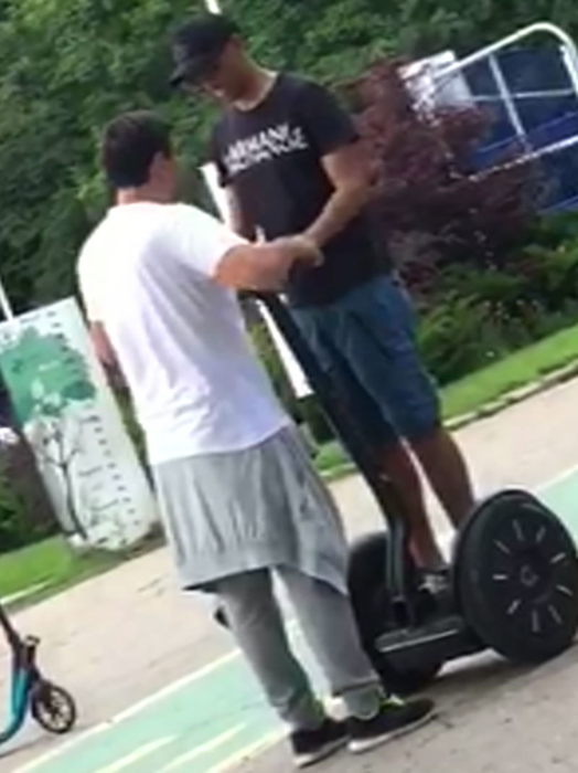 Instructorul îi explică fotbalistului cum se manevrează segway-ul