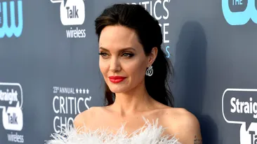 VIDEO / Nu îi pasă de gurile rele care spun că e piele şi os, ea se reinventează! Angelina Jolie a strălucit într-o superbă rochie cu pene la Premiile Critics' Choice 