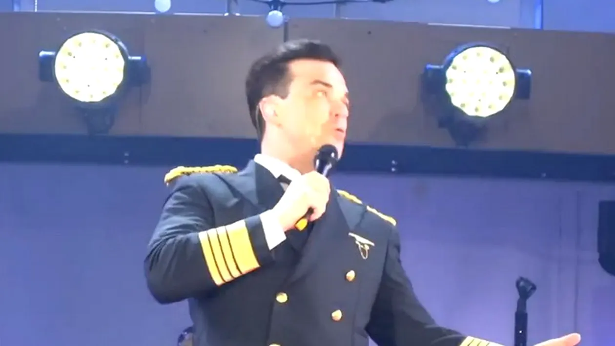 Scene de COSMAR la concertul lui Robbie Williams! Cantaretul a cazut de pe scena si a rupt mana unei femei! VIDEO