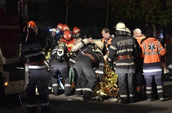 epa05004125 Romanian fireworkers and paramedics are trying to rescue a survivor of an explosion at a club, in Bucharest, Romania, early 31 October 2015. At least 26 people were killed and more than 60 were injured according to the first Interior Ministry report, in an accidental explosion, possibly triggered by mistakenly used fireworks, during a pop album launching concert.  EPA/STR