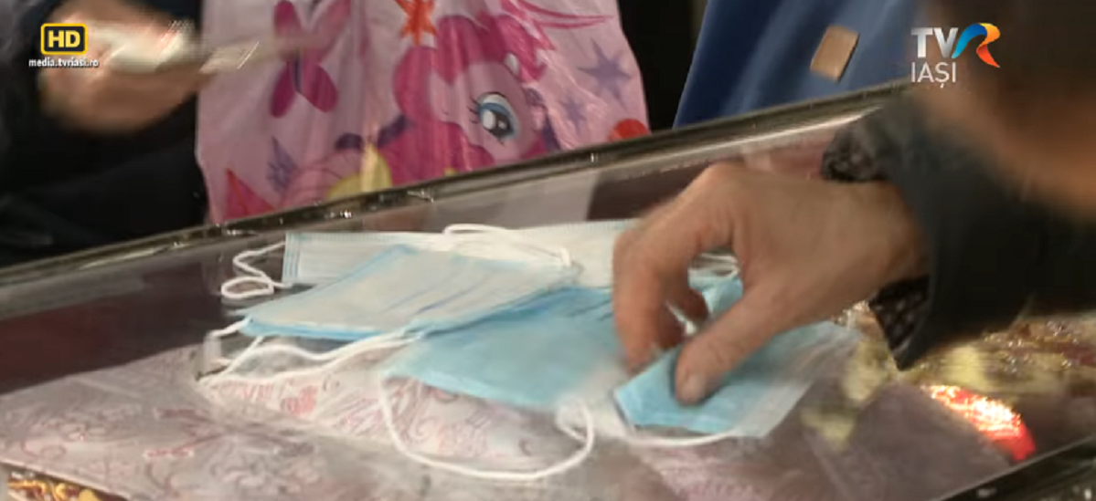 Caz șocant la Iași! Femeie filmată în timp ce șterge un mănunchi de măști de protecție de racla moaștelor Sfintei Paracheva:” Duc măștile acasă…”