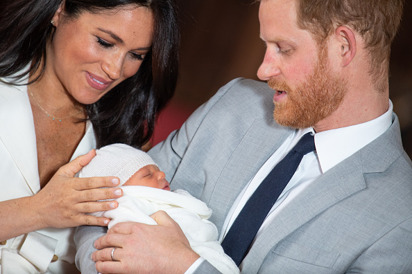 WINDSOR, ENGLAND - MAY 08: Prince Harry, Duke of Sussex and Meghan, Duchess of Sussex, pose with their newborn son Prince Archie Harrison Mountbatten-Windsor during a photocall in St George's Hall at Windsor Castle on May 8, 2019 in Windsor, England. The Duchess of Sussex gave birth at 05:26 on Monday 06 May, 2019. (Photo by Dominic Lipinski - WPA Pool/Getty Images)