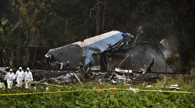 EDS NOTE: GRAPHIC CONTENT - Forensic investigators and Ministry of Interior officers sift through remains of a Boeing 737 that plummeted into a yuca field with more than 100 passengers on board, in Havana, Cuba, Friday, May 18, 2018.  (AP Photo/Ramon Espinosa)