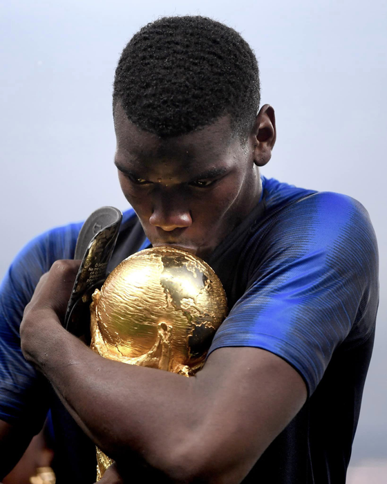 MOSCOW, RUSSIA - JULY 15: Paul Pogba of France kisses the World Cup trophy following the 2018 FIFA World Cup Final between France and Croatia at Luzhniki Stadium on July 15, 2018 in Moscow, Russia.  (Photo by Laurence Griffiths/Getty Images)