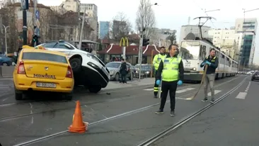 VIDEO / Accident spectaculos în Bucureşti! O maşină de poliţie s-a ciocnit violent cu un taxi, pe care l-a strivit