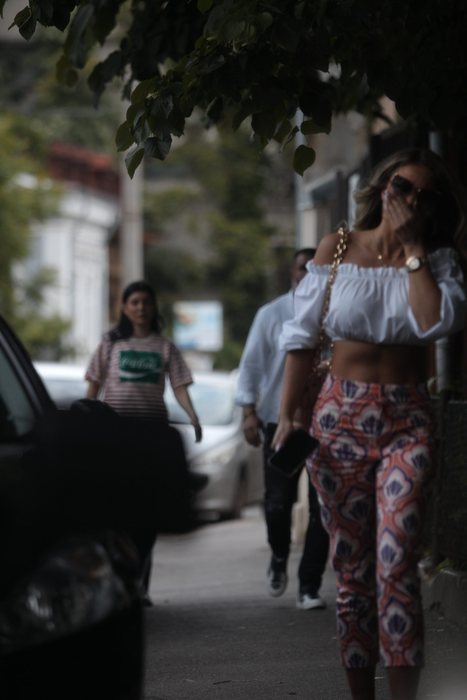 Bianca Drăgușanu a ieșit din curtea salonului  și se îndreaptă către mașină, urmărită de Alex Bodi